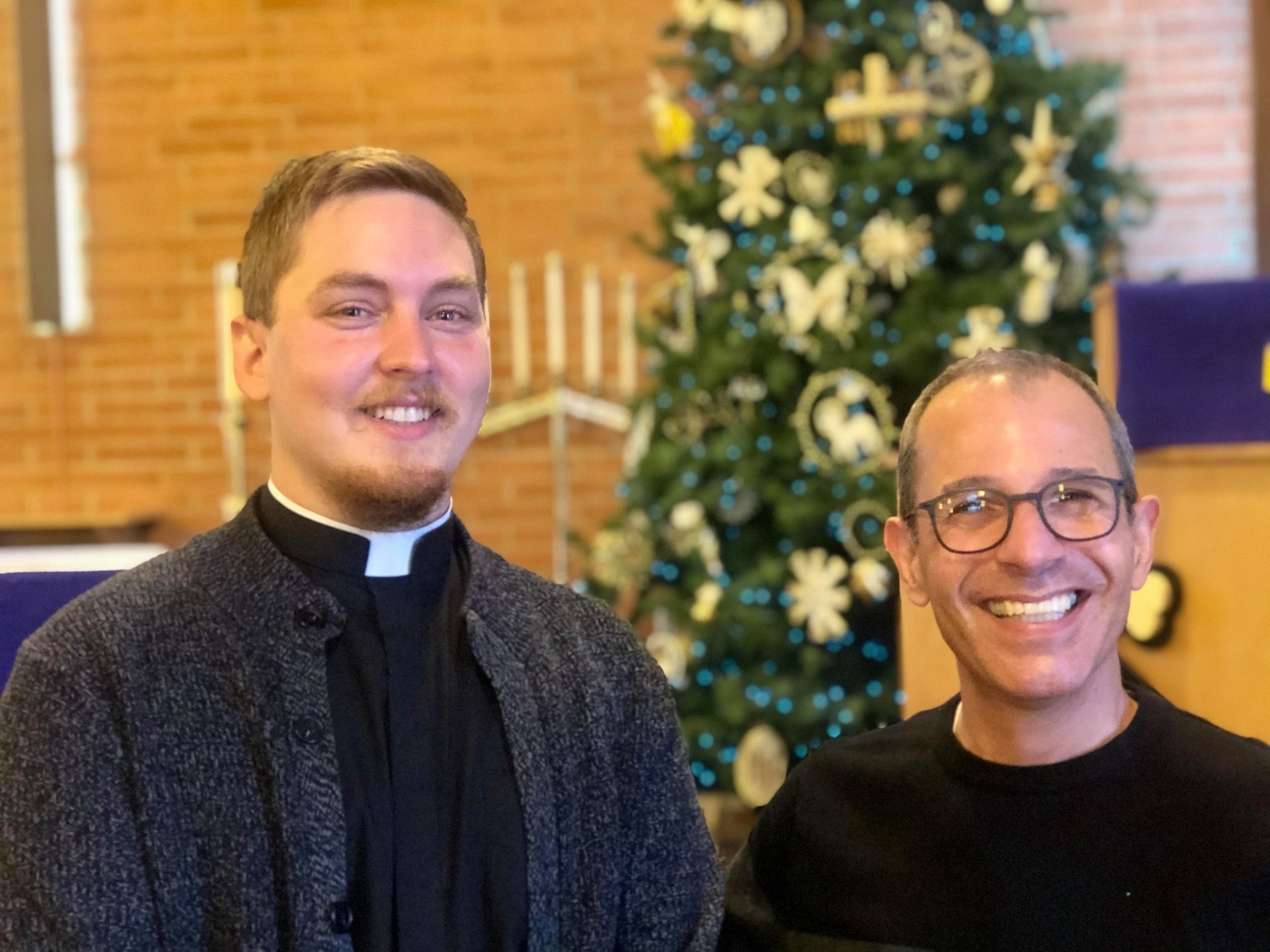 Pastor and church leader smiling together in the sanctuary
